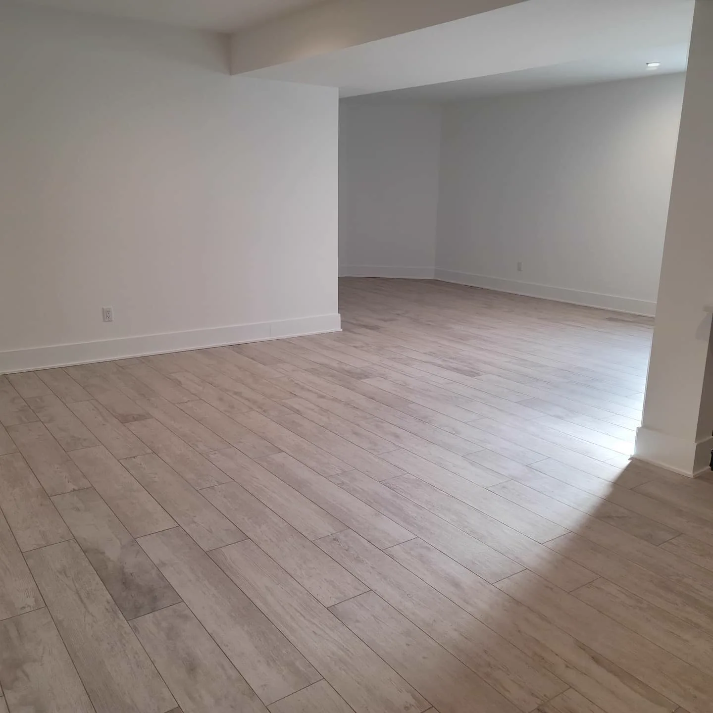 Wood-look porcelain plank flooring through an open living space