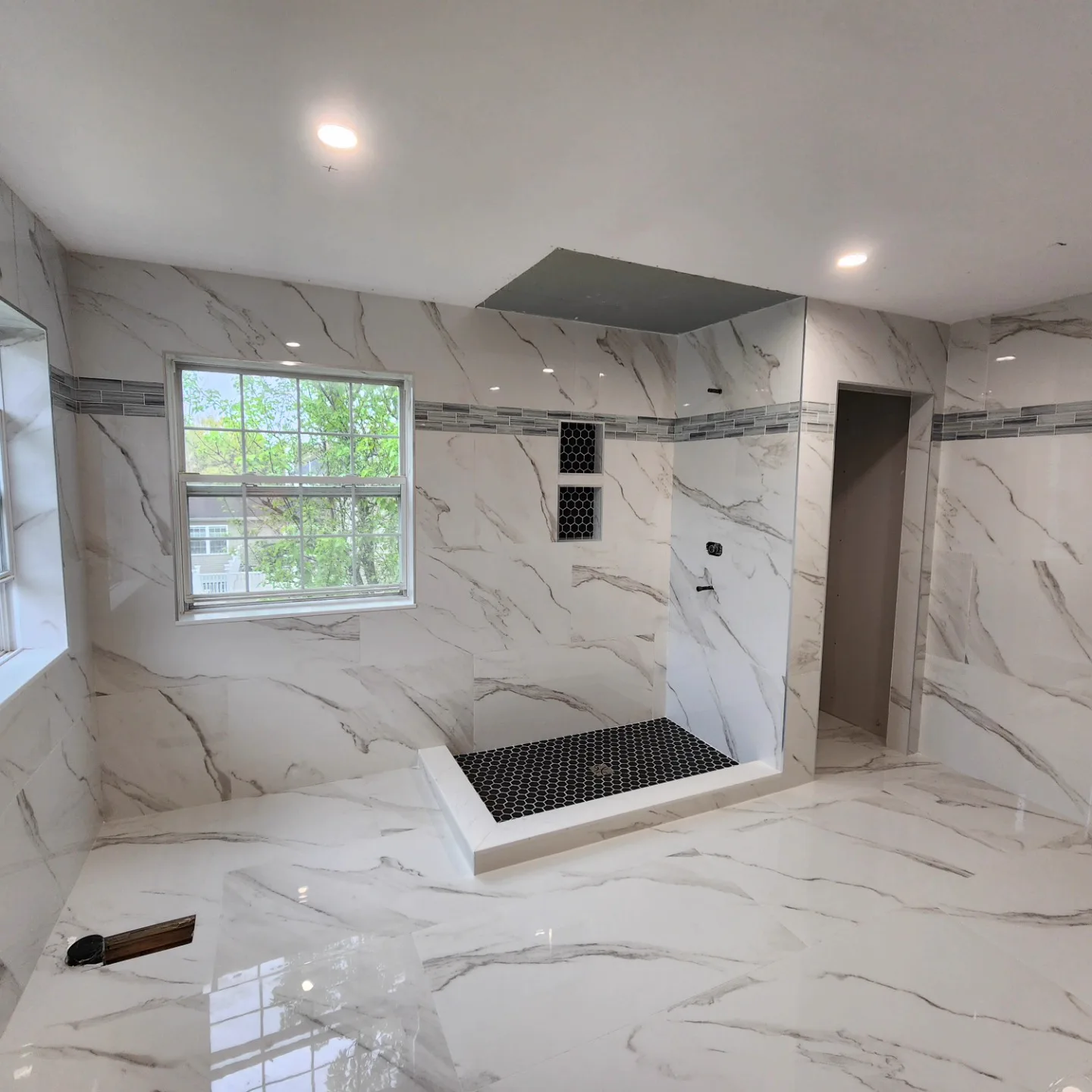 Curbless marble walk-in shower