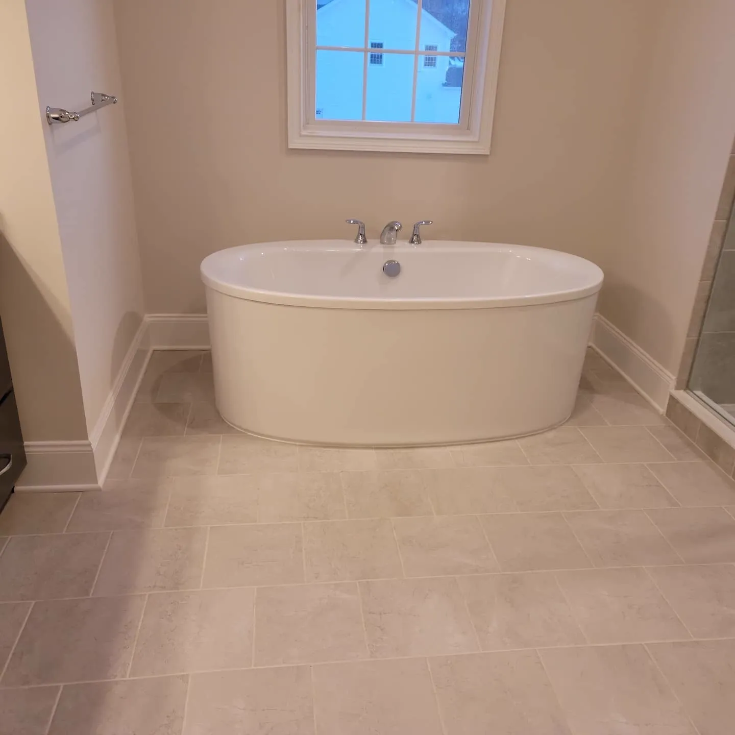 Freestanding oval tub by a window